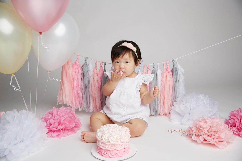 one year old baby girl cake smash portraits in singapore studio