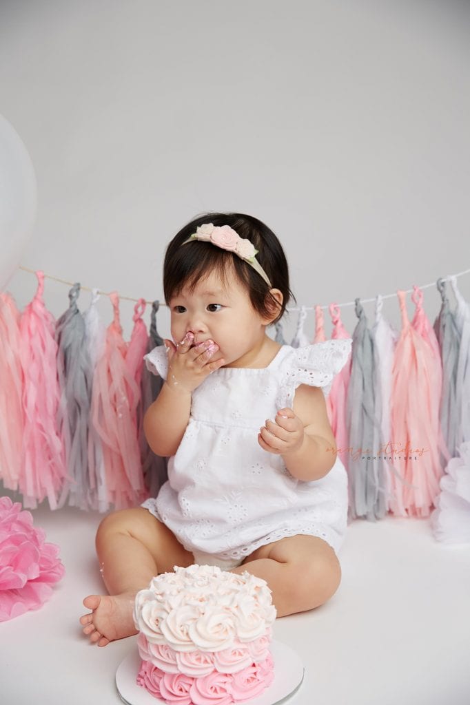 one year old baby girl cake smash portraits in singapore studio