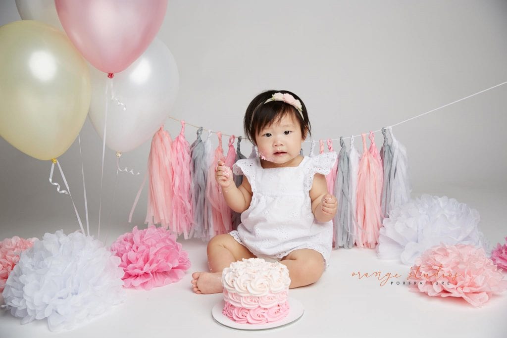 one year old baby girl cake smash portraits in singapore studio