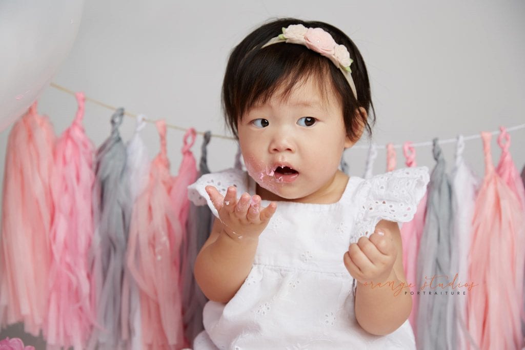 one year old baby girl cake smash portraits in singapore studio