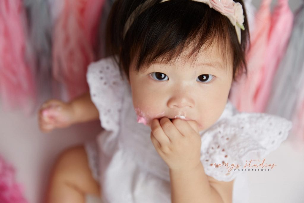 one year old baby girl cake smash portraits in singapore studio