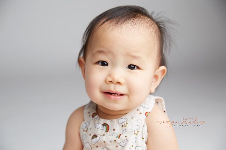 one year old smiling baby girl portraits in singapore studio