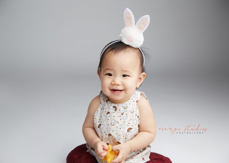 one year old smiling baby girl portraits in singapore studio