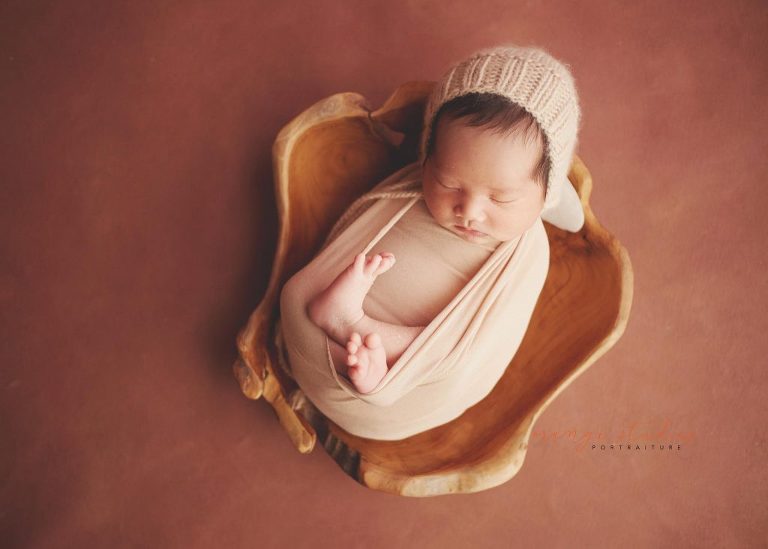 13 days old baby boy in wooden bowl prop newborn portraits in singapore studio