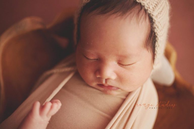 13 days old baby boy in wooden bowl prop newborn portraits in singapore studio