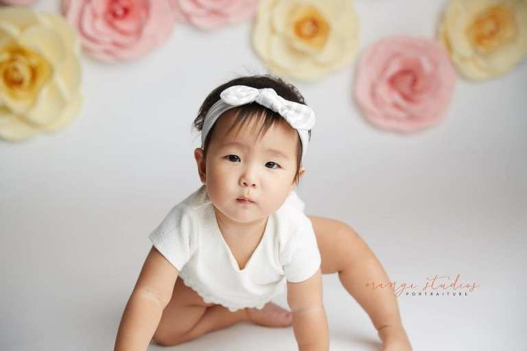 one year old baby girl floral cake smash portraits in singapore studio