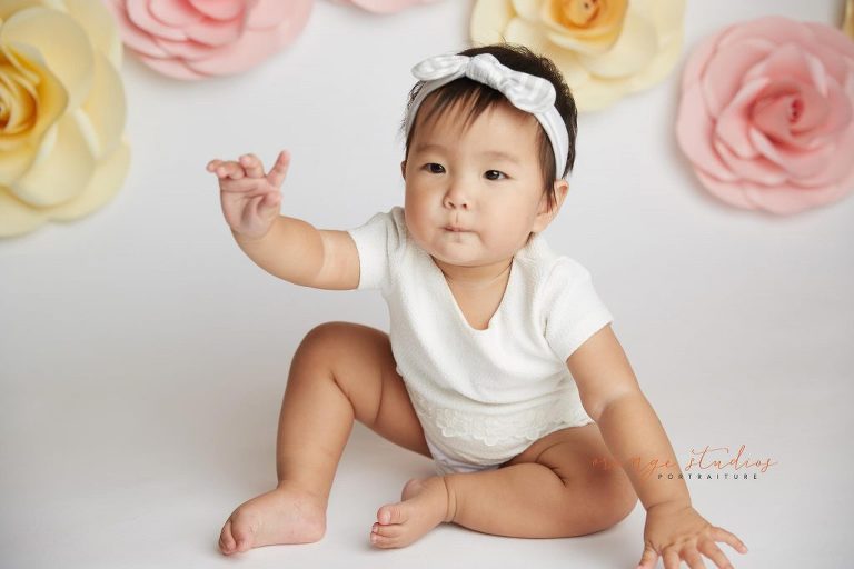 one year old baby girl floral cake smash portraits in singapore studio