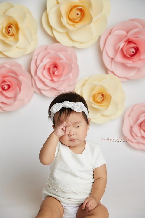 one year old baby girl floral cake smash portraits in singapore studio