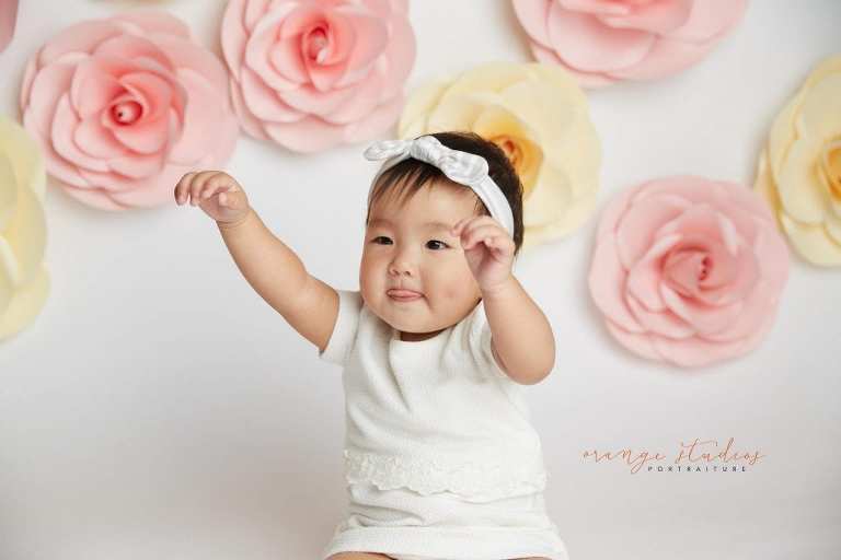 one year old baby girl floral cake smash portraits in singapore studio