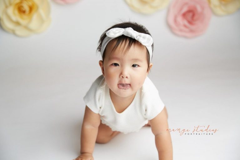 one year old baby girl floral cake smash portraits in singapore studio