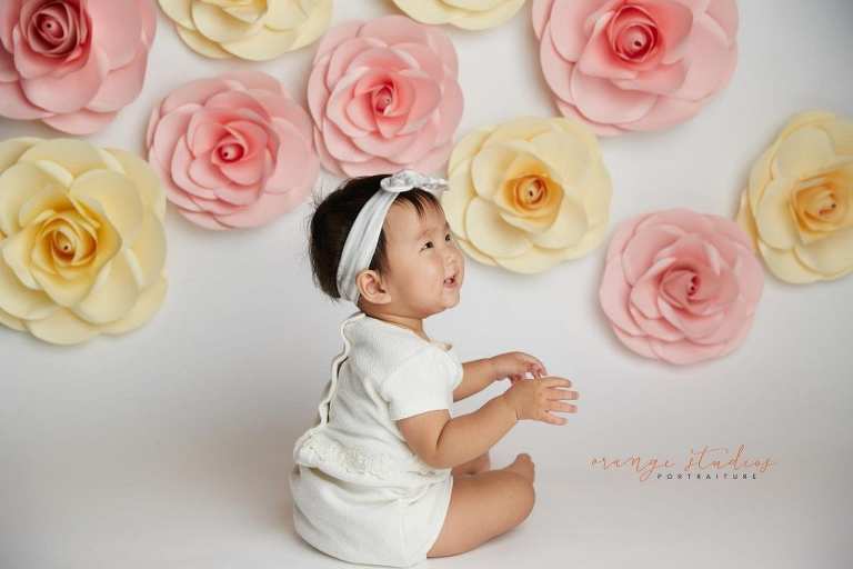 one year old baby girl floral cake smash portraits in singapore studio