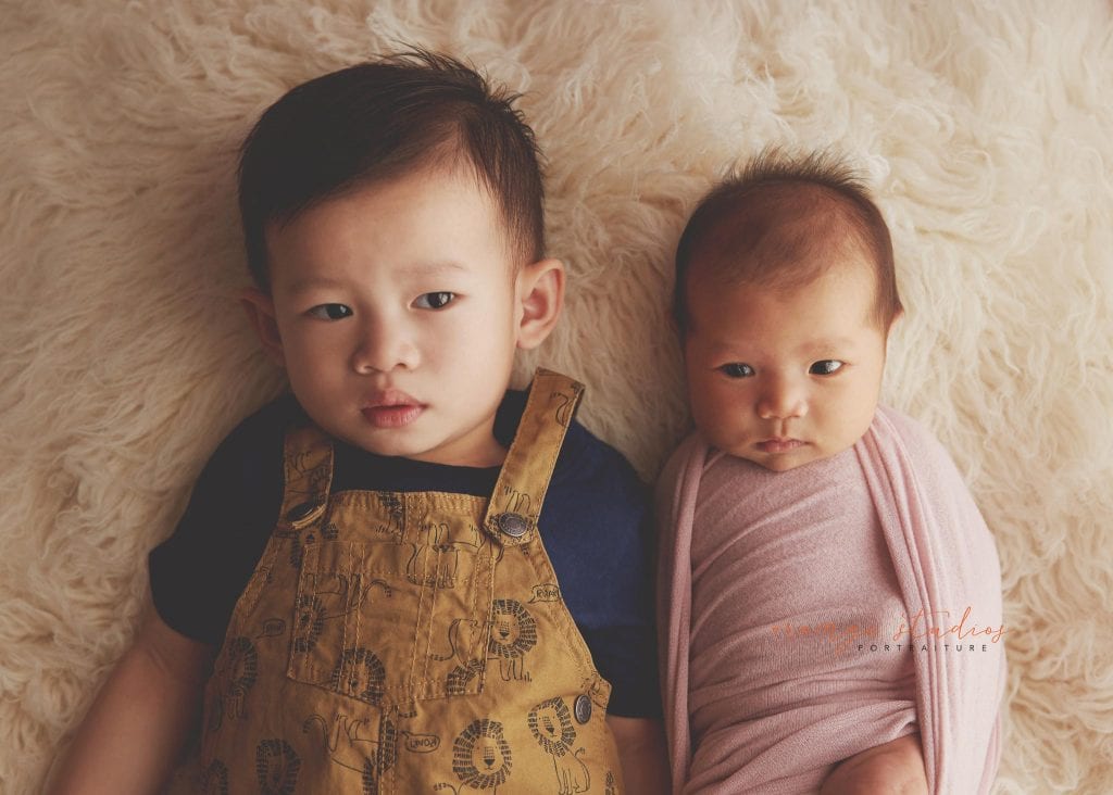 4 weeks old baby girl newborn portraits with elder brother in singapore studio
