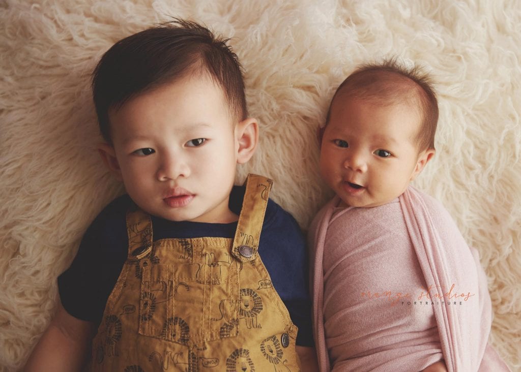 4 weeks old baby girl newborn portraits with elder brother in singapore studio