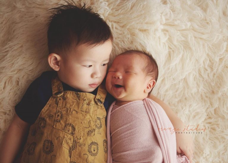 sweet 4 weeks old baby girl newborn portraits with elder brother in singapore studio