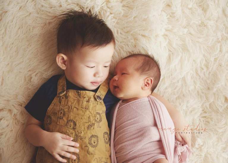 sweet 4 weeks old baby girl newborn portraits with elder brother in singapore studio