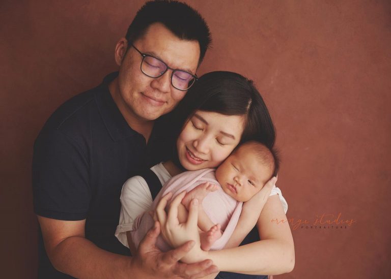 4 weeks old baby girl with parents newborn portraits in singapore studio