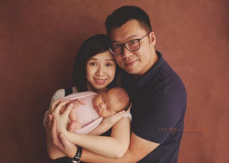 4 weeks old baby girl with parents newborn portraits in singapore studio