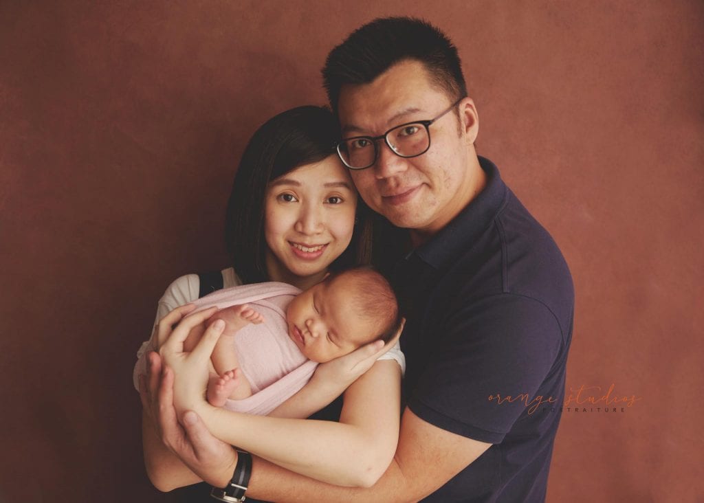 4 weeks old baby girl with parents newborn portraits in singapore studio