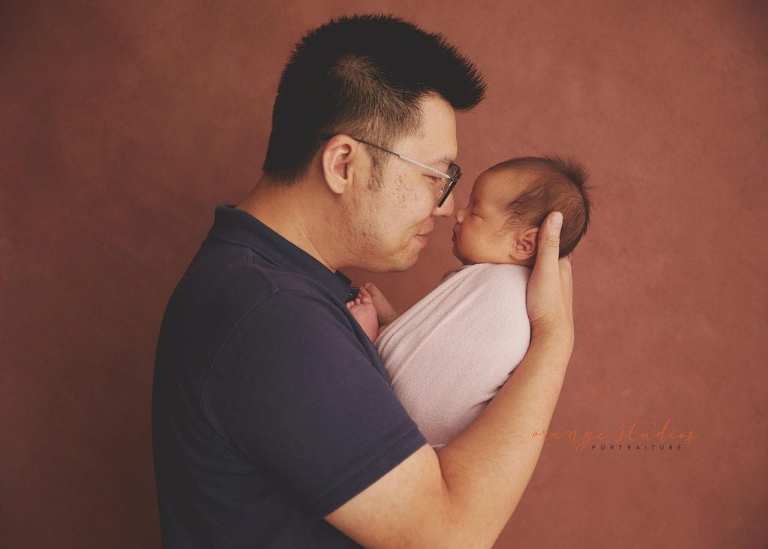 4 weeks old baby girl with dad newborn portraits in singapore studio