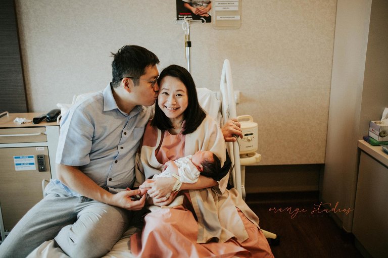 Emotional first moments of new parents holding their newborn during a Fresh 48 session in Singapore