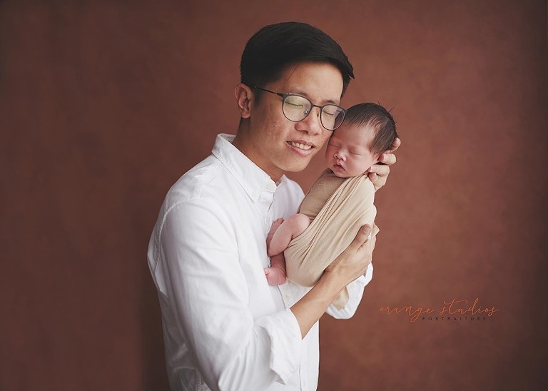 2 weeks old baby girl with dad newborn portraits in singapore studio