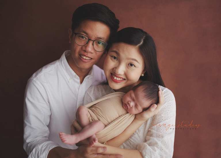 2 weeks old baby girl with parents newborn portraits in singapore studio