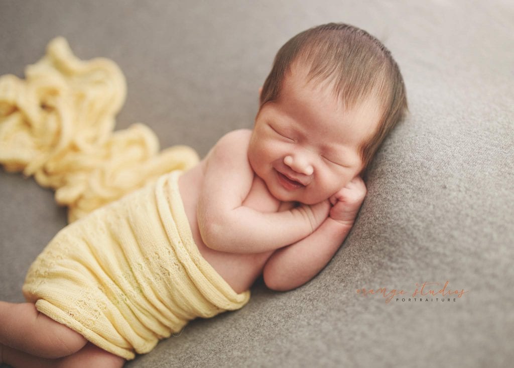 2 weeks old smiling baby girl newborn portraits in singapore studio