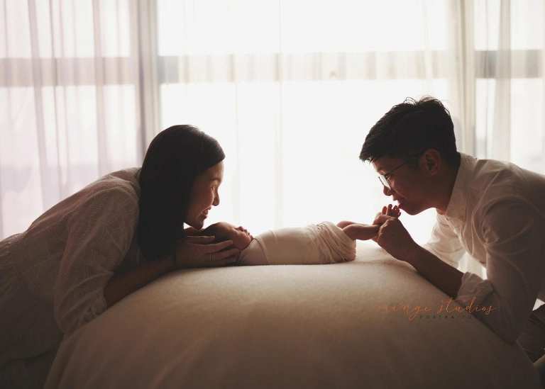 2 weeks old baby girl with parents newborn portraits in singapore studio