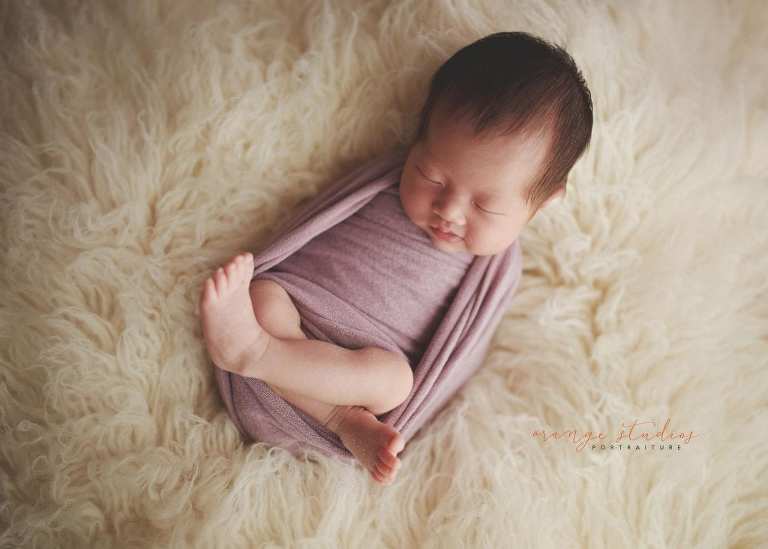 2 weeks old smiling baby girl newborn portraits in singapore studio