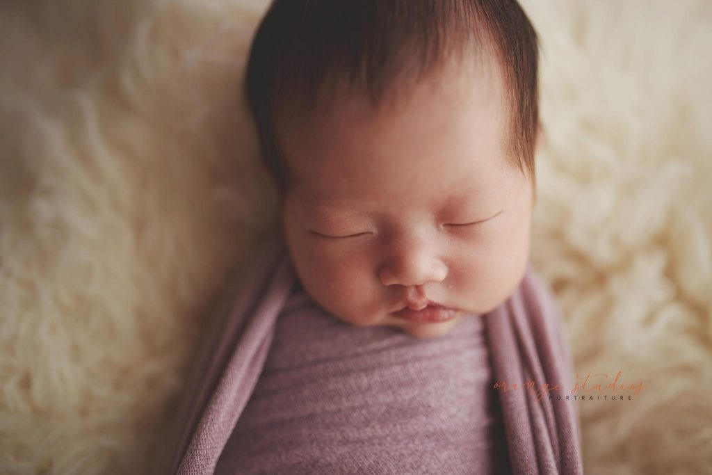 2 weeks old baby girl with dimple newborn portraits in singapore studio