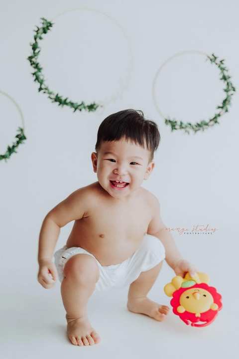 one year old smiling baby boy portraits in singapore studio