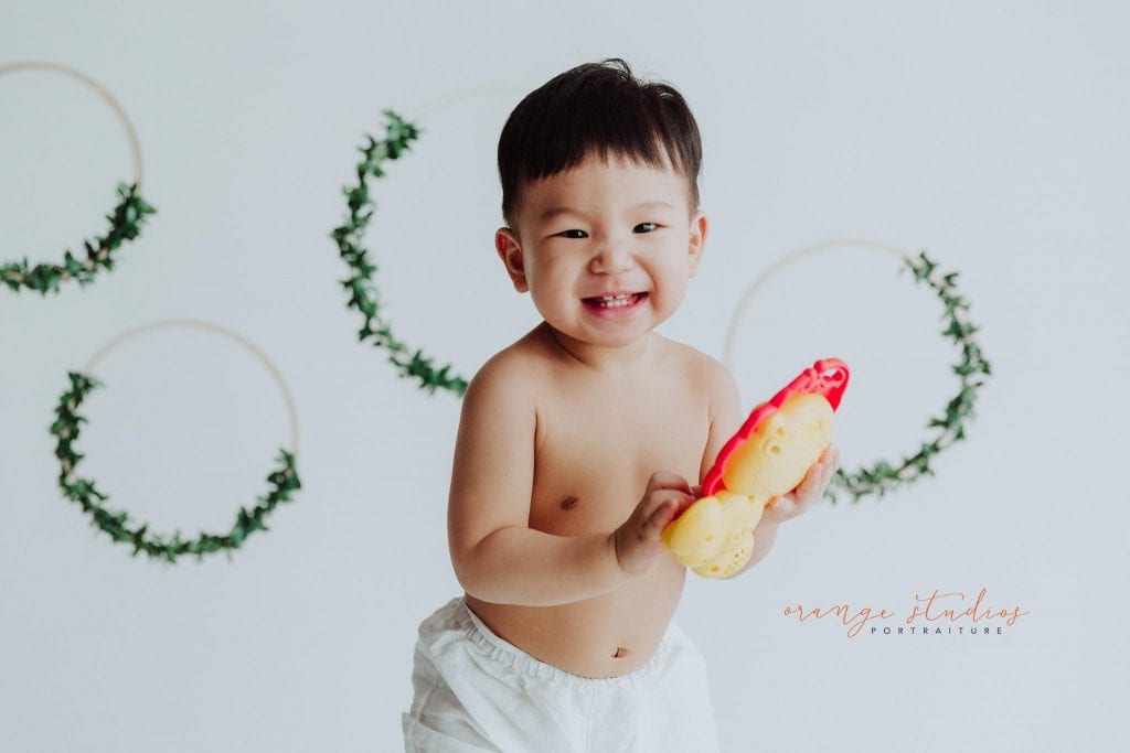 one year old smiling baby boy portraits in singapore studio