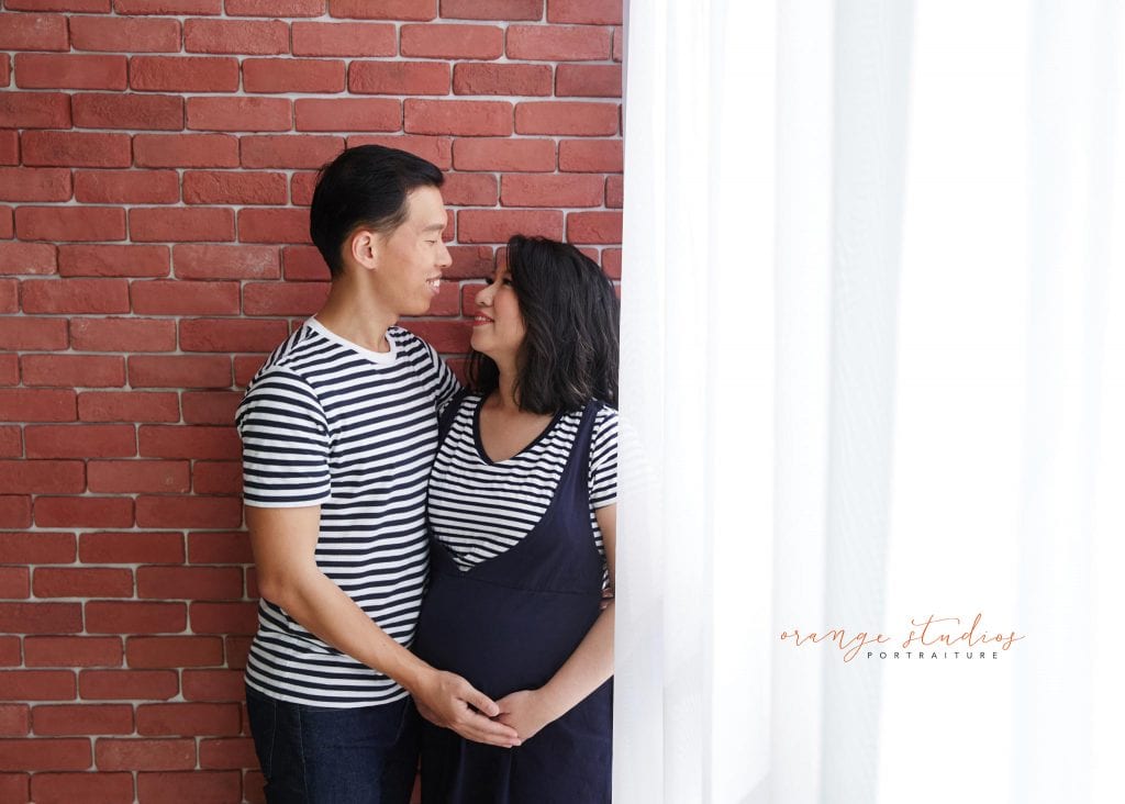 maternity portraits with husband in singapore studio natural light