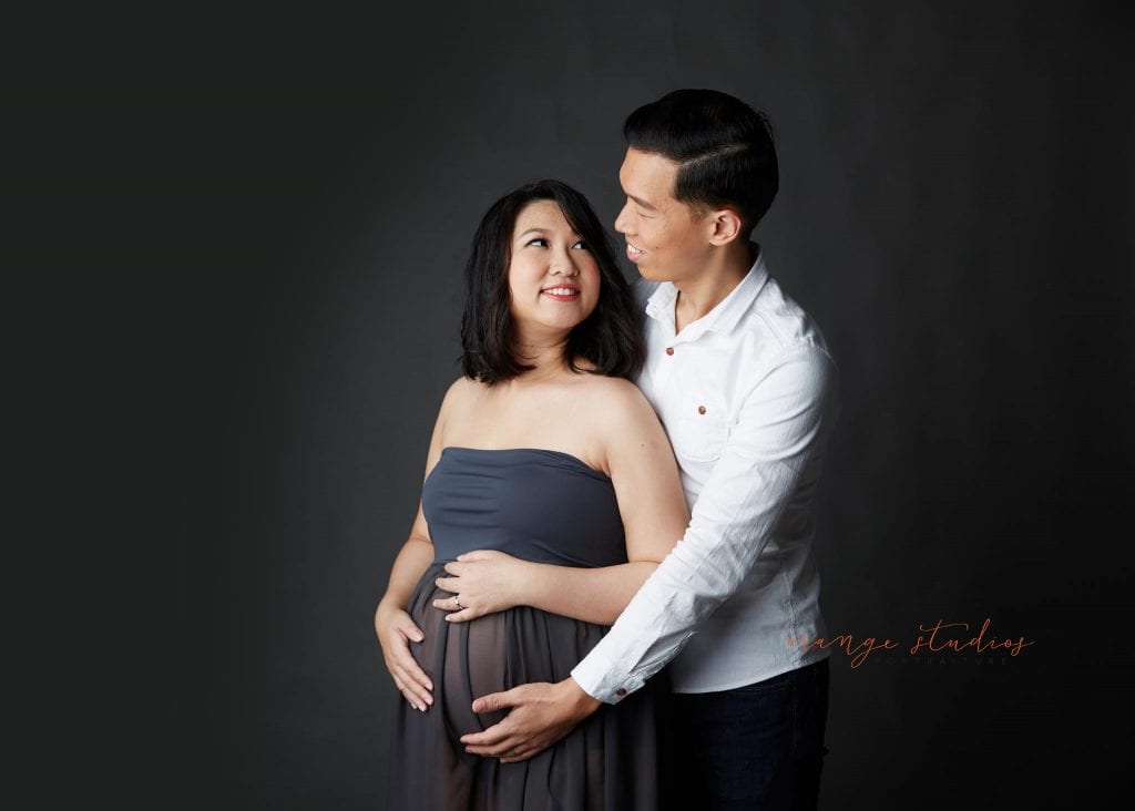 elegant and classy maternity portraits with husband in singapore studio