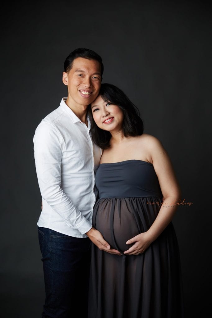 elegant and classy maternity portraits with husband in singapore studio