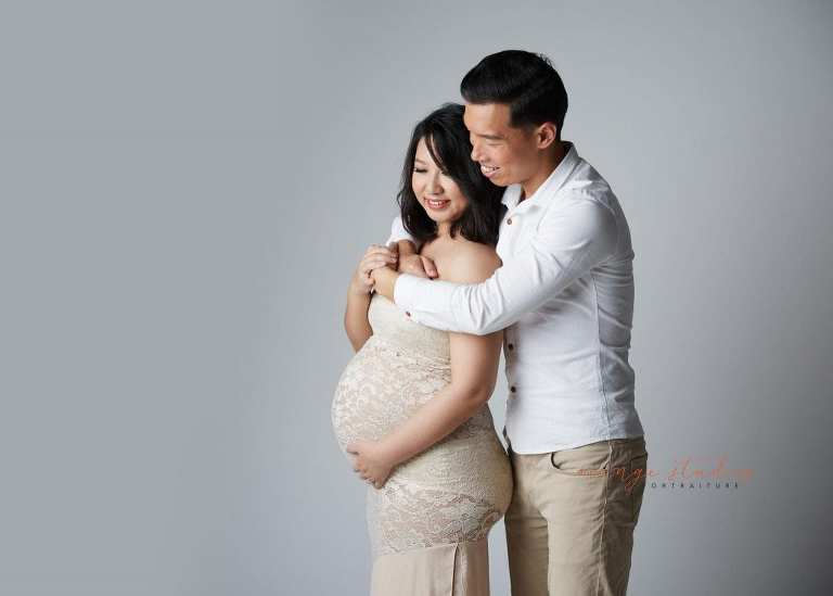 elegant and classy maternity portraits with husband in singapore studio