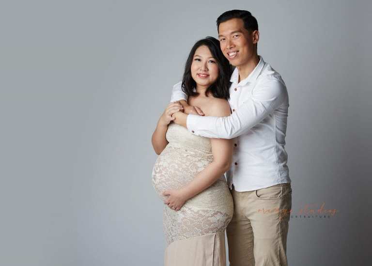 elegant and classy maternity portraits with husband in singapore studio