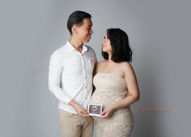elegant and classy maternity portraits with husband in singapore studio