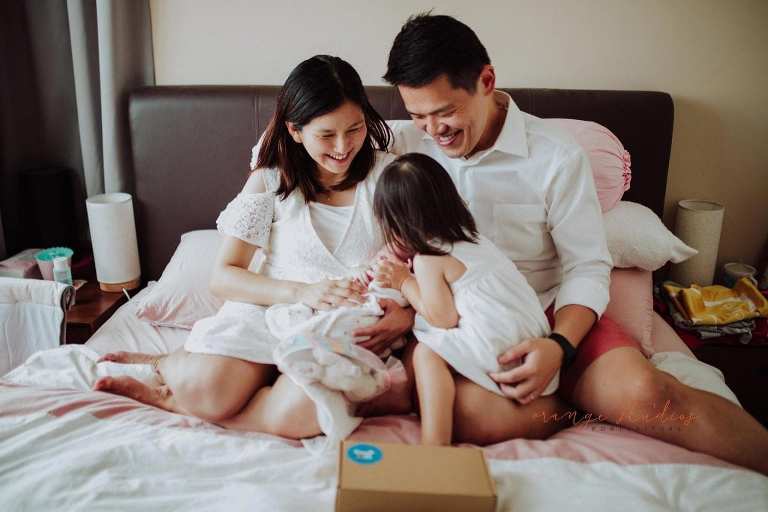 elder sister kissing younger sister during fresh 48 photoshoot at home