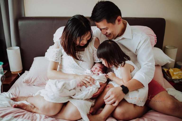 elder sister kissing younger sister during fresh 48 photoshoot at home