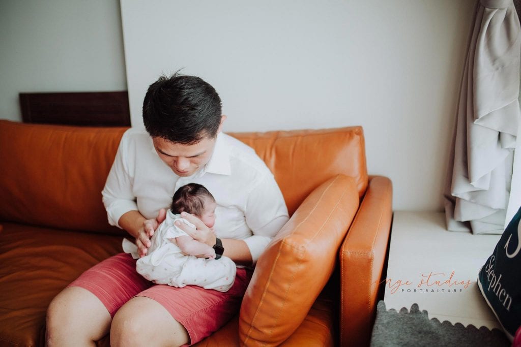 2 days old newborn baby girl with dad during fresh 48 photoshoot at home