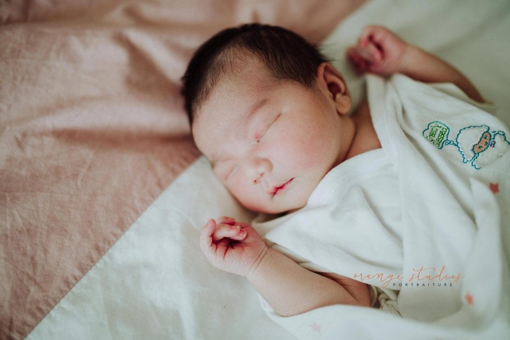 2 days old newborn baby girl during fresh 48 photoshoot at home