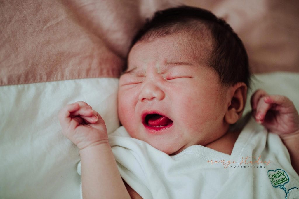 2 days old newborn baby girl during fresh 48 photoshoot at home