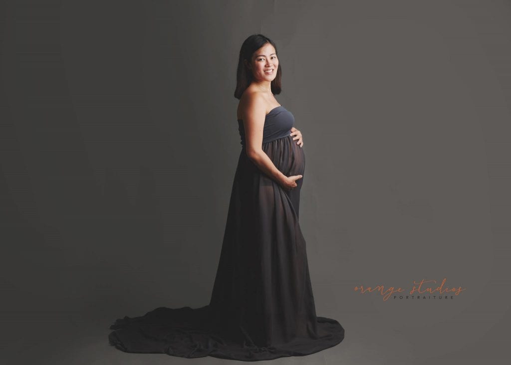 maternity portraits in grey gown in singapore studio