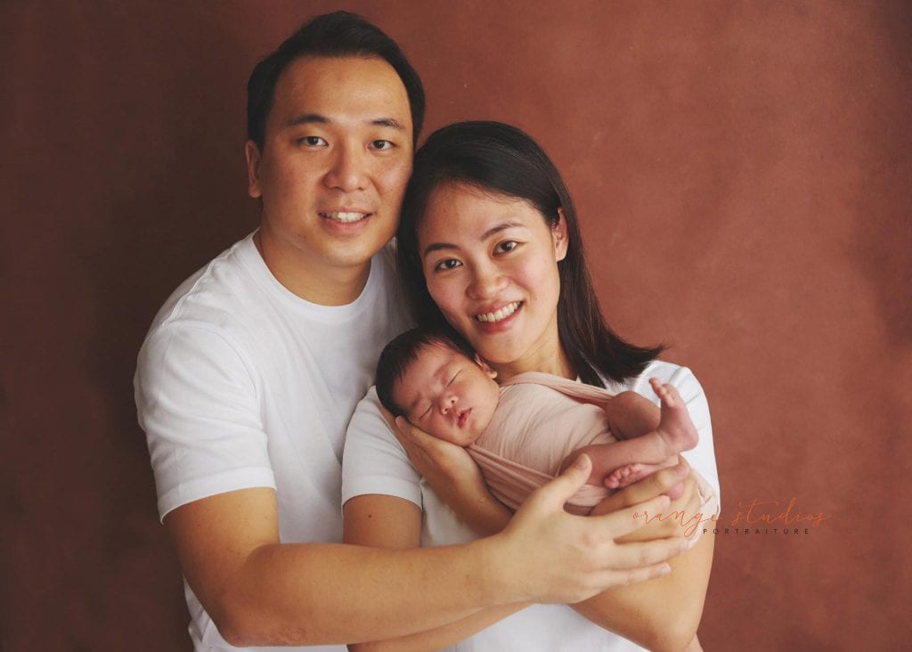 11 days old newborn baby girl portraits with parents in singapore home natural lighting