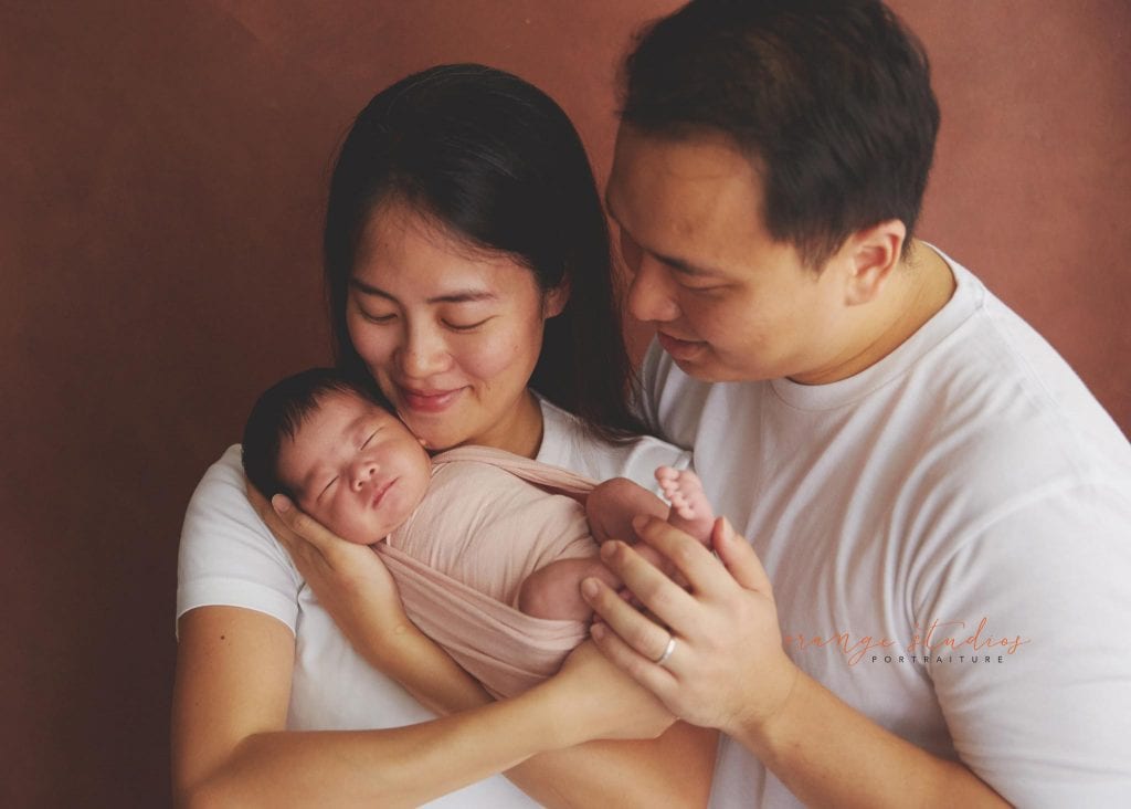 11 days old newborn baby girl portraits with parents in singapore home natural lighting
