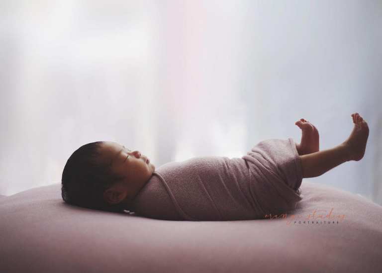 adorable 11 days old newborn baby girl stretching her legs