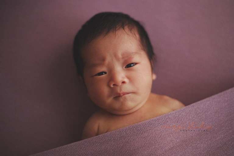 cute frowning newborn baby girl