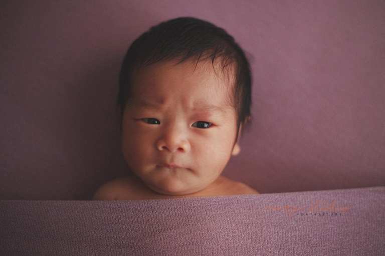 cute frowning newborn baby girl