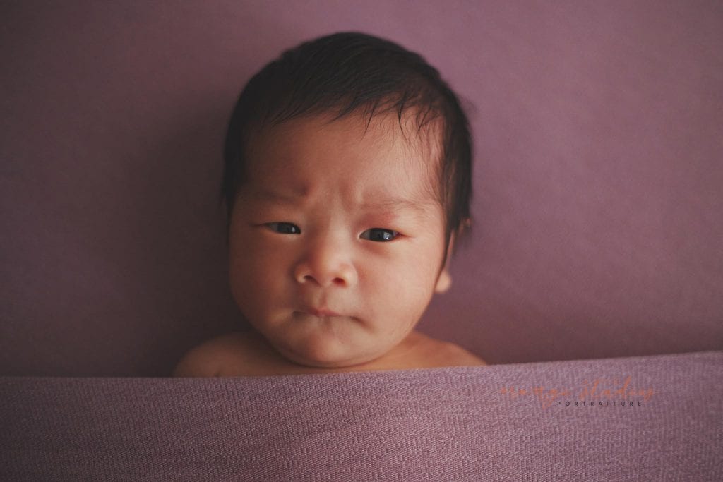 cute frowning newborn baby girl